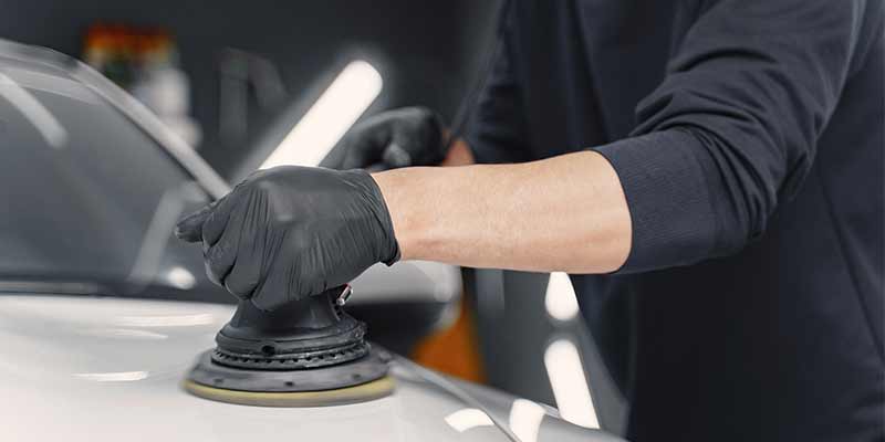 man buffing a car paint